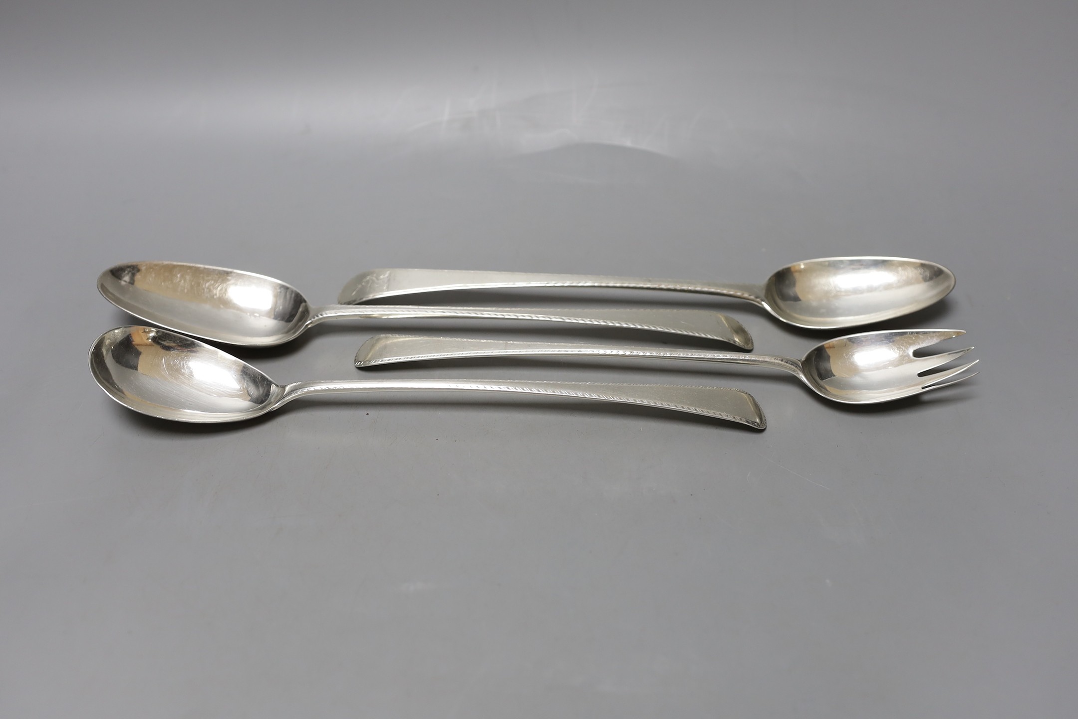 Two George III silver Old English pattern feather edge basting spoons and a pair of similar servers, various makers and dates, marks rubbed, approx. 28.5cm, 11.5oz.